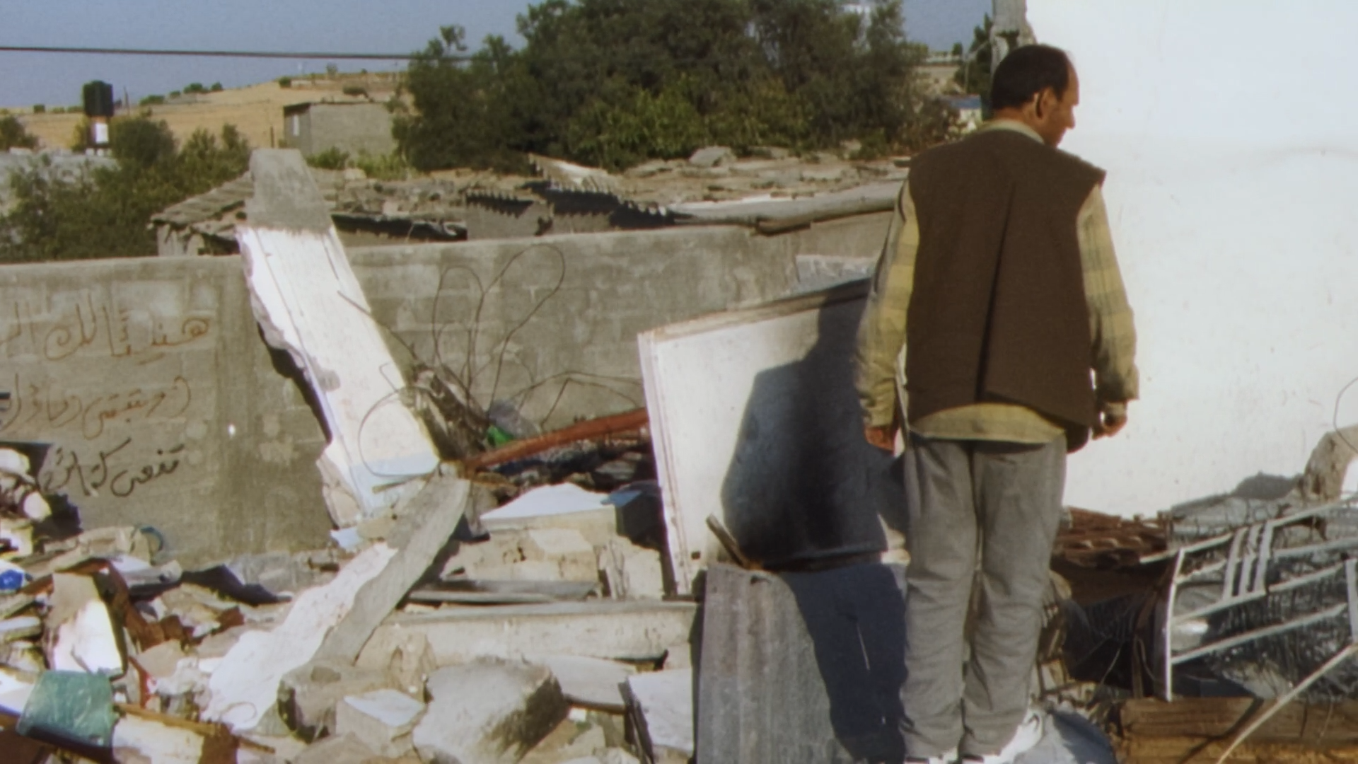 A still from the film 'With Hasan in Gaza' of a man amidst rubble.